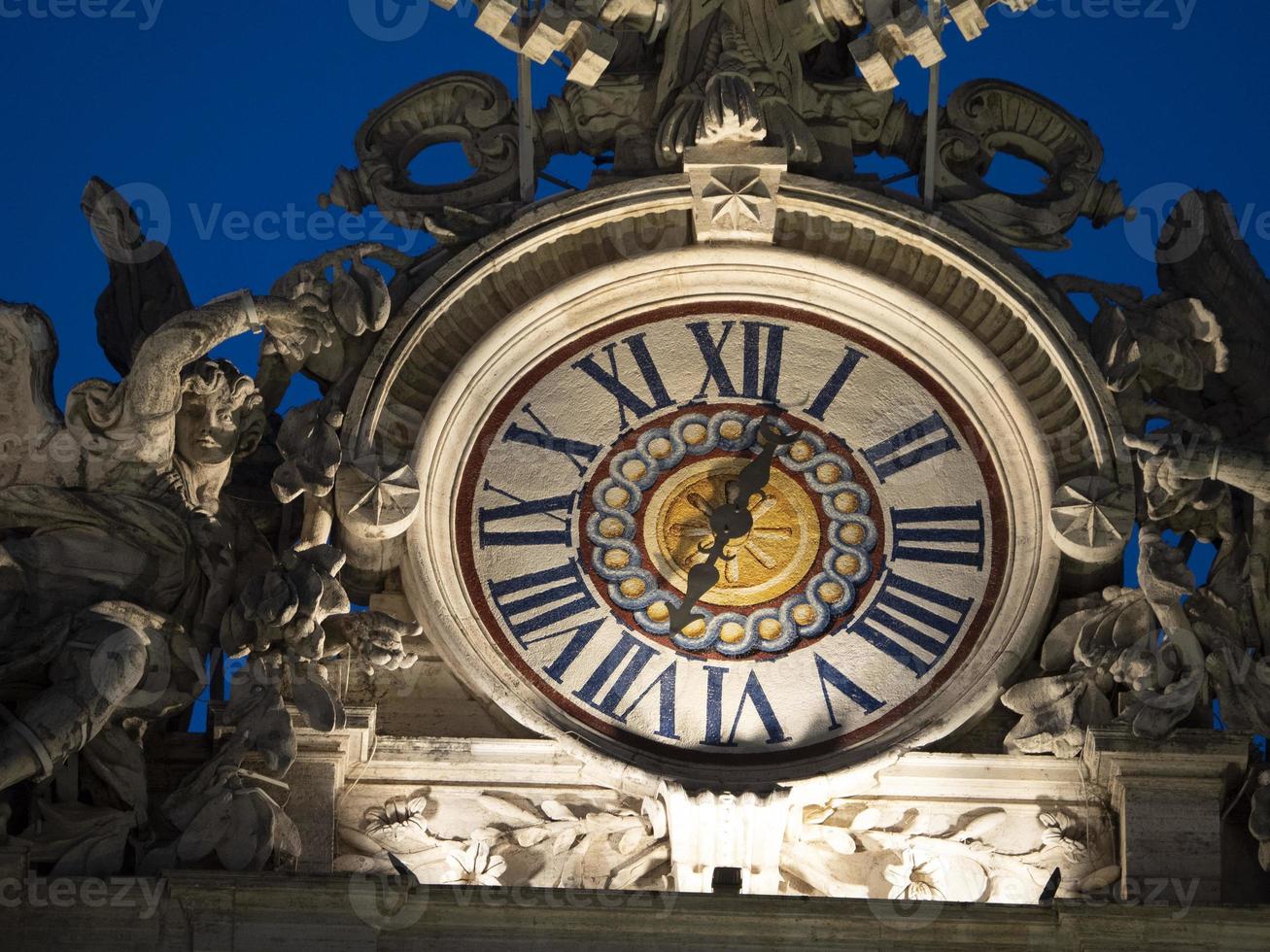 illuminated san pietro saint peter vatican rome clock at night photo