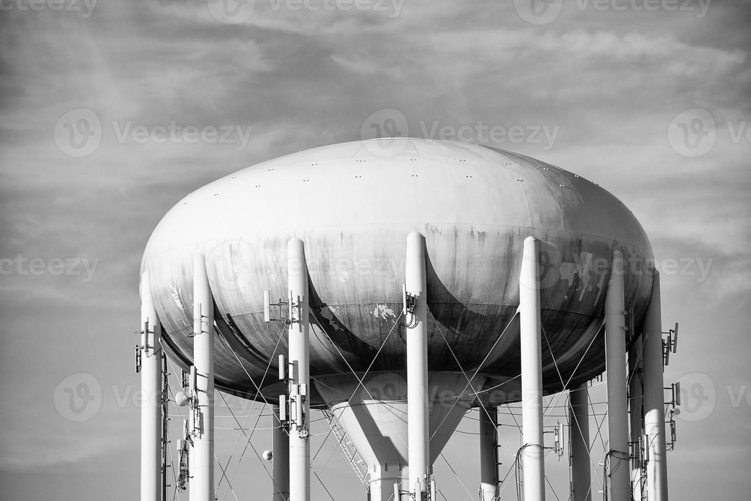 una torre de agua en el cielo azul profundo en blanco y negro foto