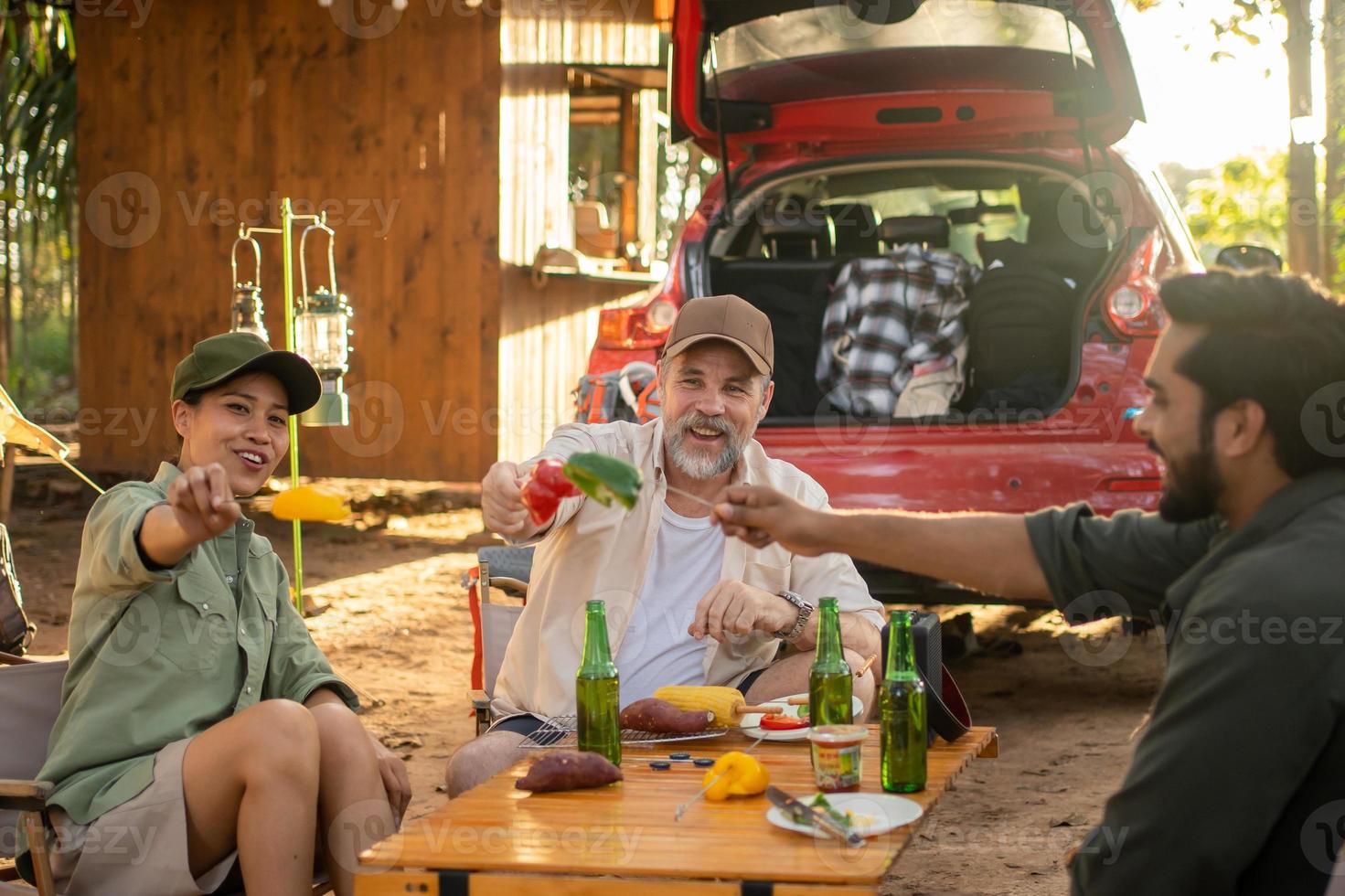 Group tourists Friends camping and having a barbecue and drinking beer-alcohol  with party together with enjoyment and happiness in Summer photo