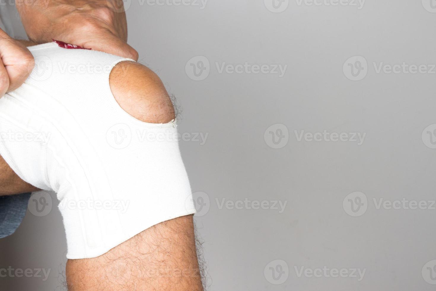 Man wearing an elastic type ace bandage on his knee photo