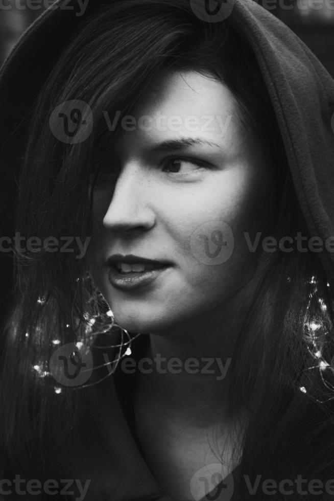 Close up young woman with lights garland monochrome portrait picture photo