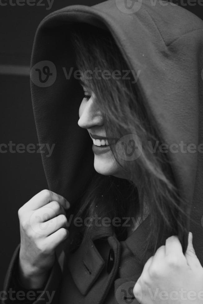 Close up smiling woman with large hood monochrome portrait picture photo