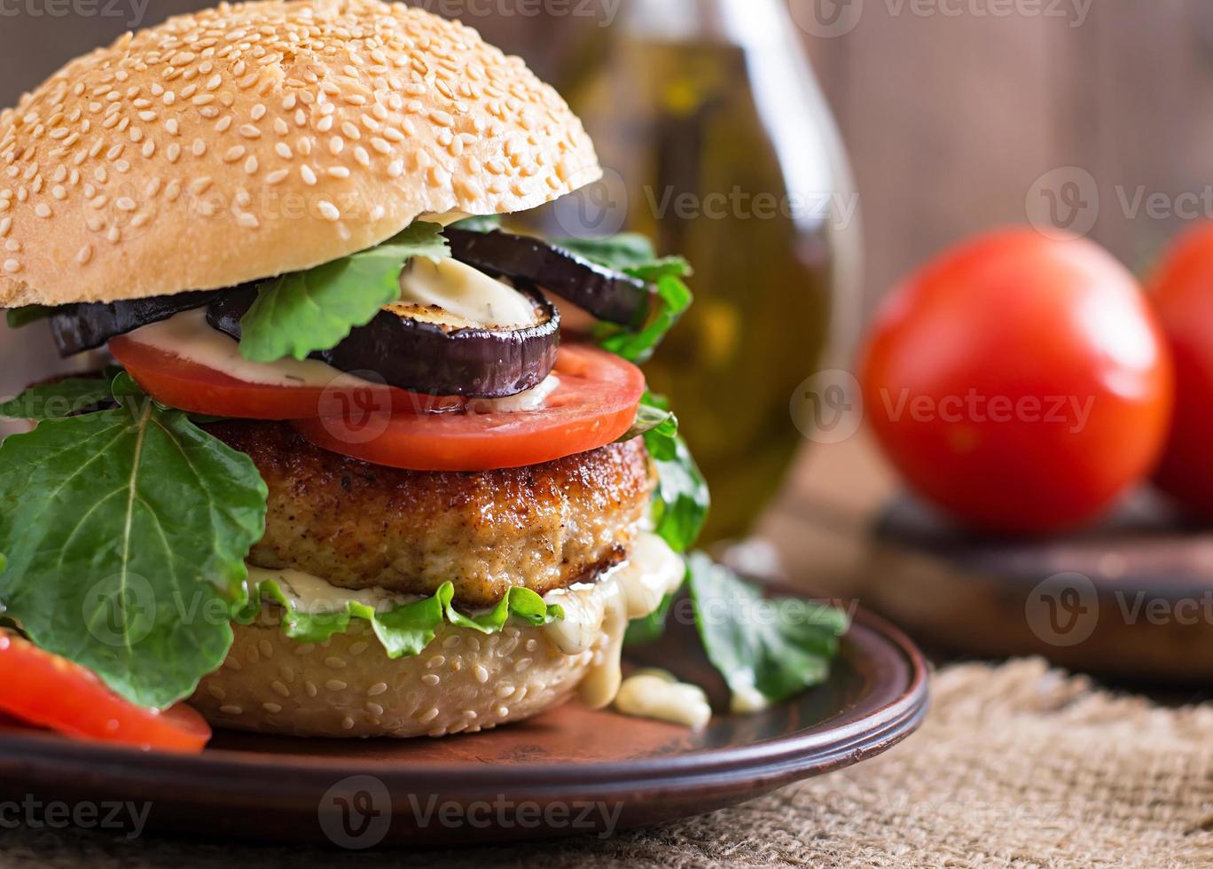Sandwich with chicken burger, tomatoes and lettuce photo