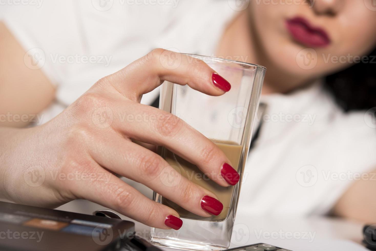 portrait of young woman drinking coffee at table photo