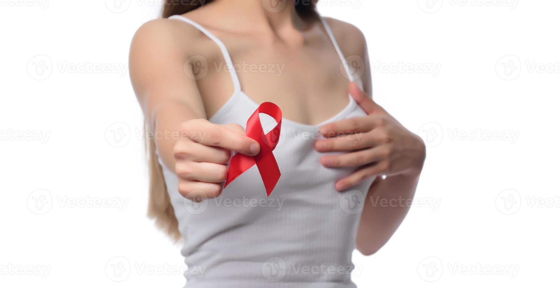 Woman holding red ribbon for December world aids day. Healthcare concept photo