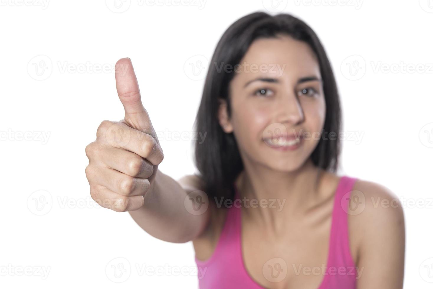 Closeup of female hand showing thumbs up sign against white background. photo