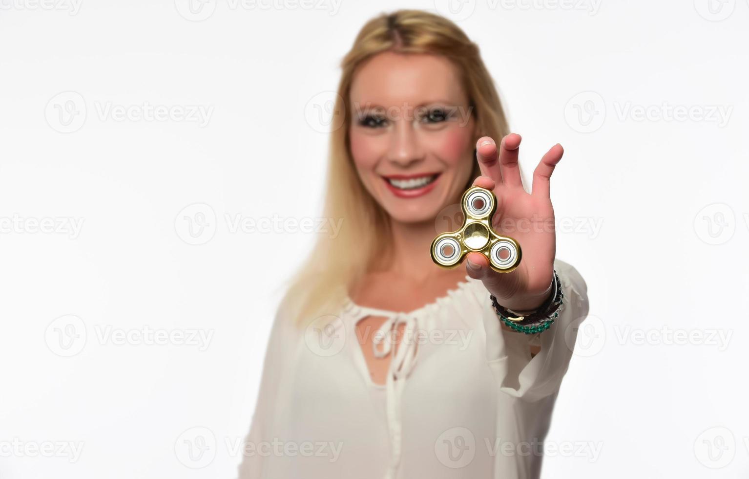 Girl to play with Fidget Spinner in his hands, the concept of relieving stress, develop a small hand mathematics. photo