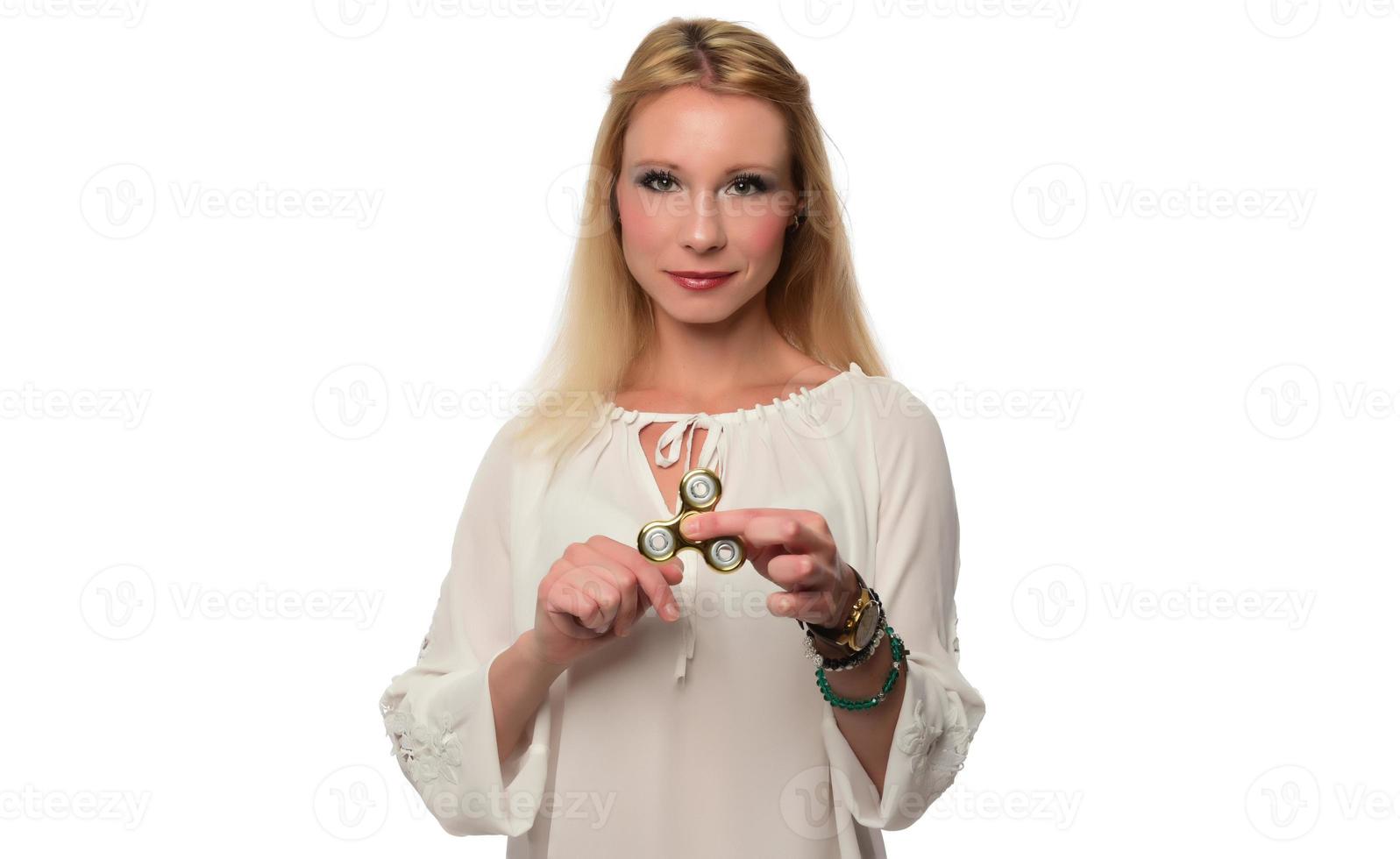 Girl to play with Fidget Spinner in his hands, the concept of relieving stress, develop a small hand mathematics. photo