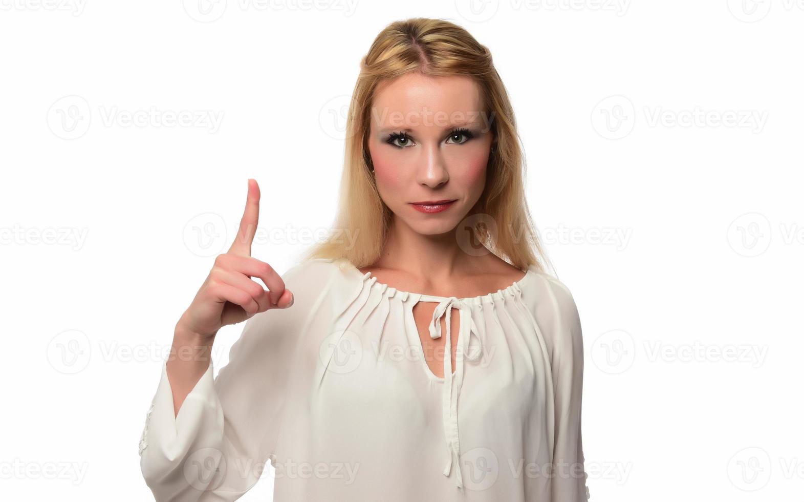 Enthusiastic motivated attractive young woman giving a thumbs up gesture of approval and success with a beaming smile photo