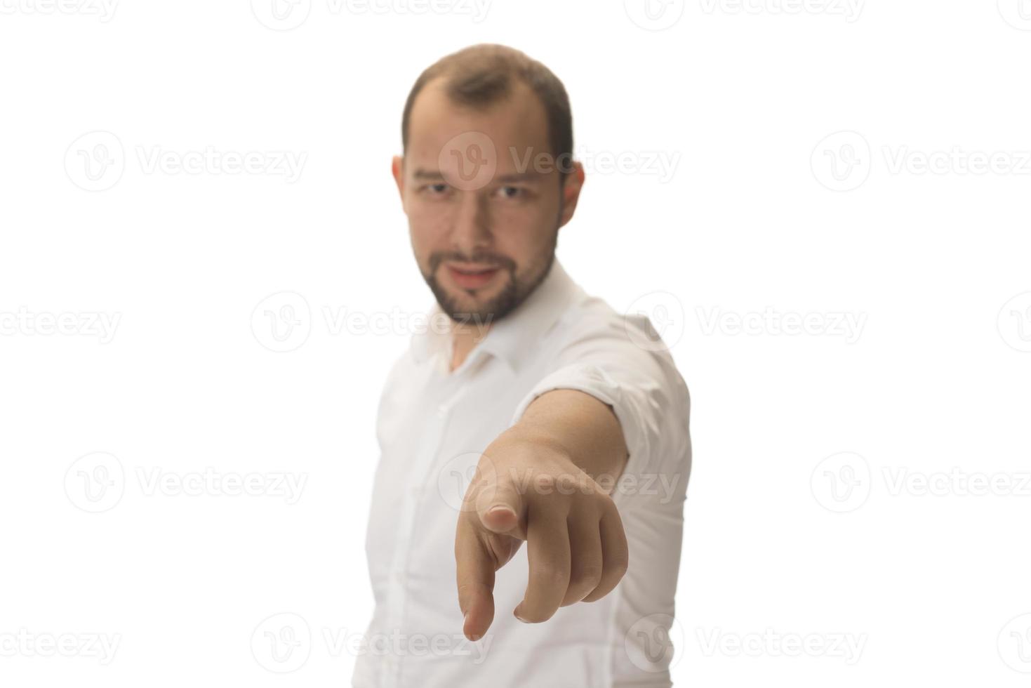 Portrait of young man pointing forward, looking at camera. Choosing someone concept photo