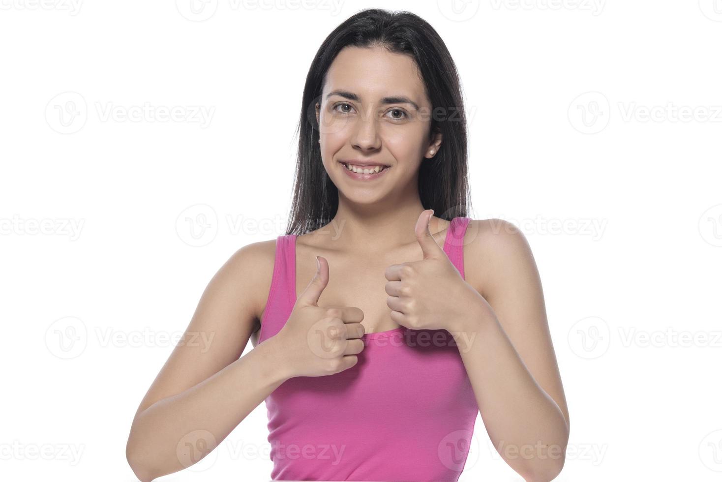 Closeup of female hand showing thumbs up sign against white background. photo