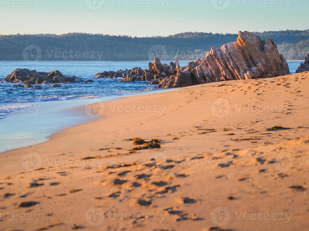 Seaside rock formation on the beach in Australia photo