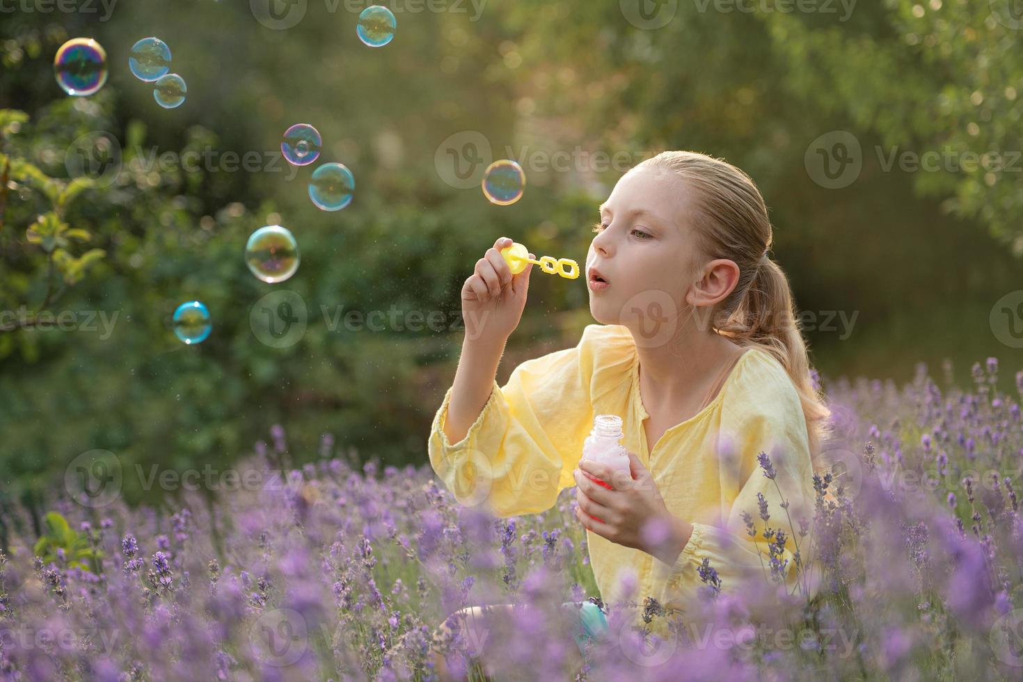 Beautiful little girl in a field with lavender. photo