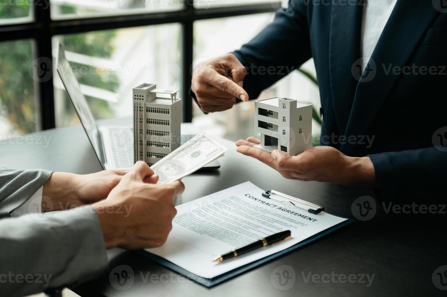 Signing a contract. Client and broker agent, lease agreement, successful deal and  Young business sitting at the desk photo