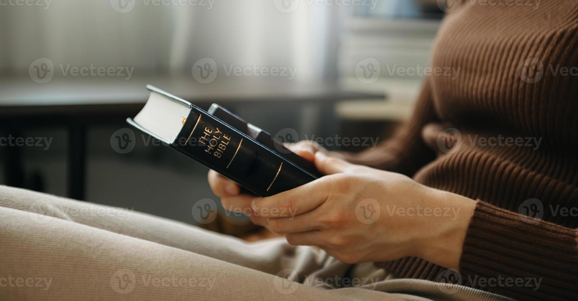 Hands together in prayer to God along with the bible In the Christian concept and religion, woman pray in the Bible photo