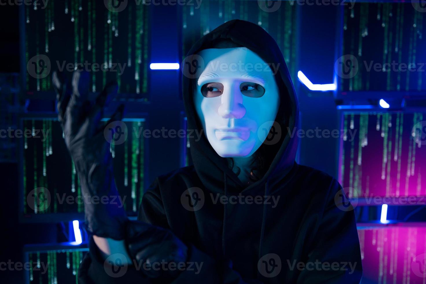 A Hacker is using laptop computer to steal data in the night photo