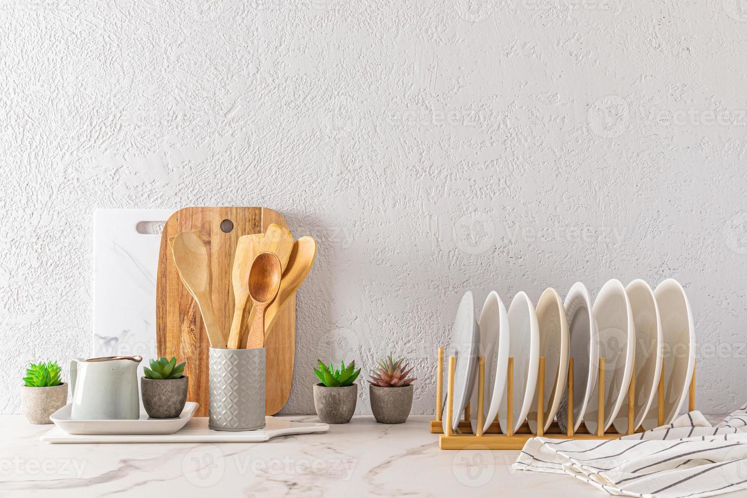 front view of the eco-friendly utensils in the modern classic kitchen. gray background of the cement wall. space for text. photo