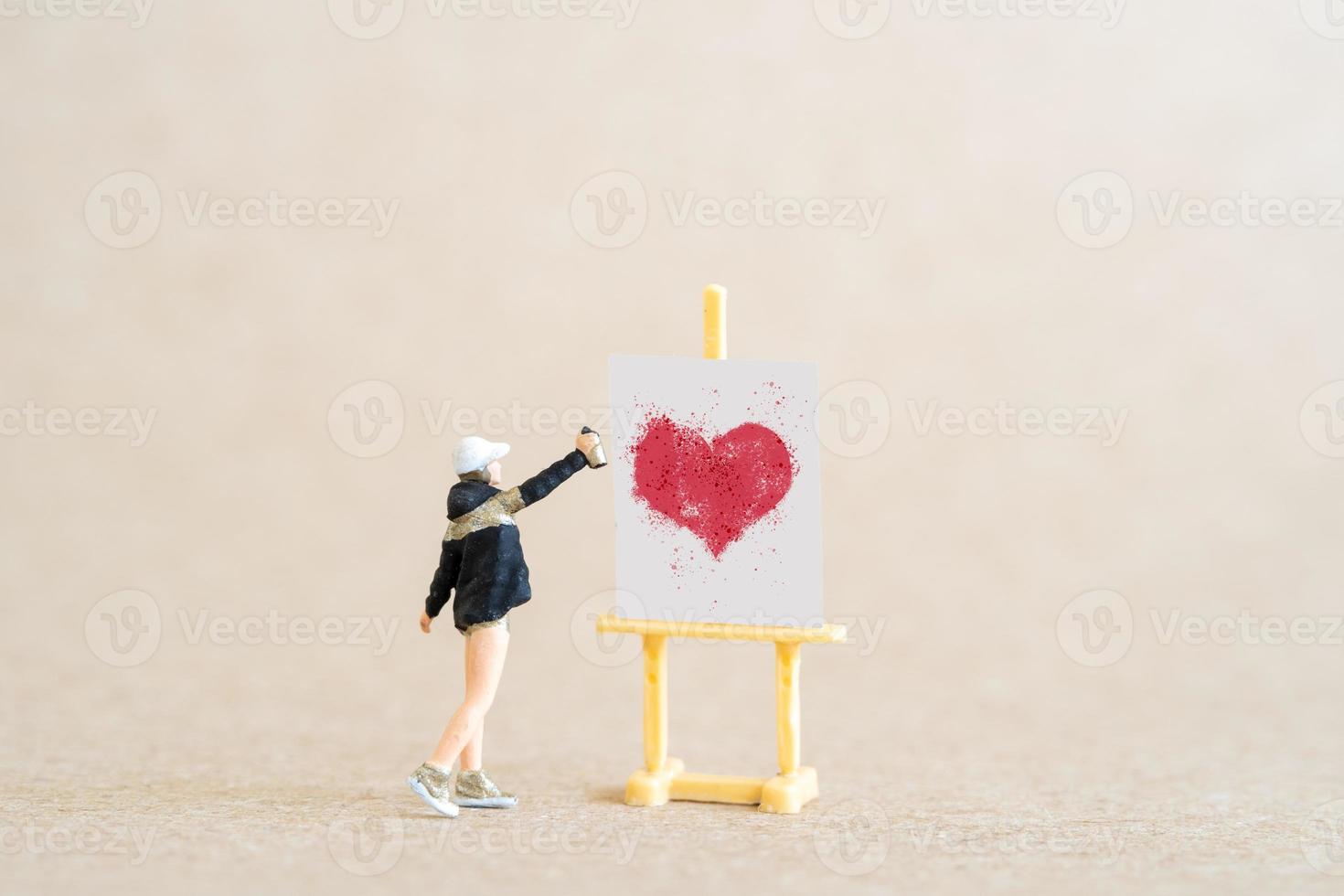 Artist holding dispenser and spraying with red heart shapes, Valentine day concept photo