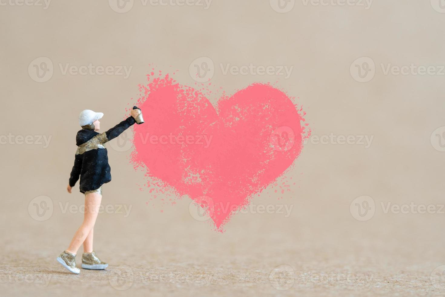 Artist holding dispenser and spraying with red heart shapes, Valentine day concept photo