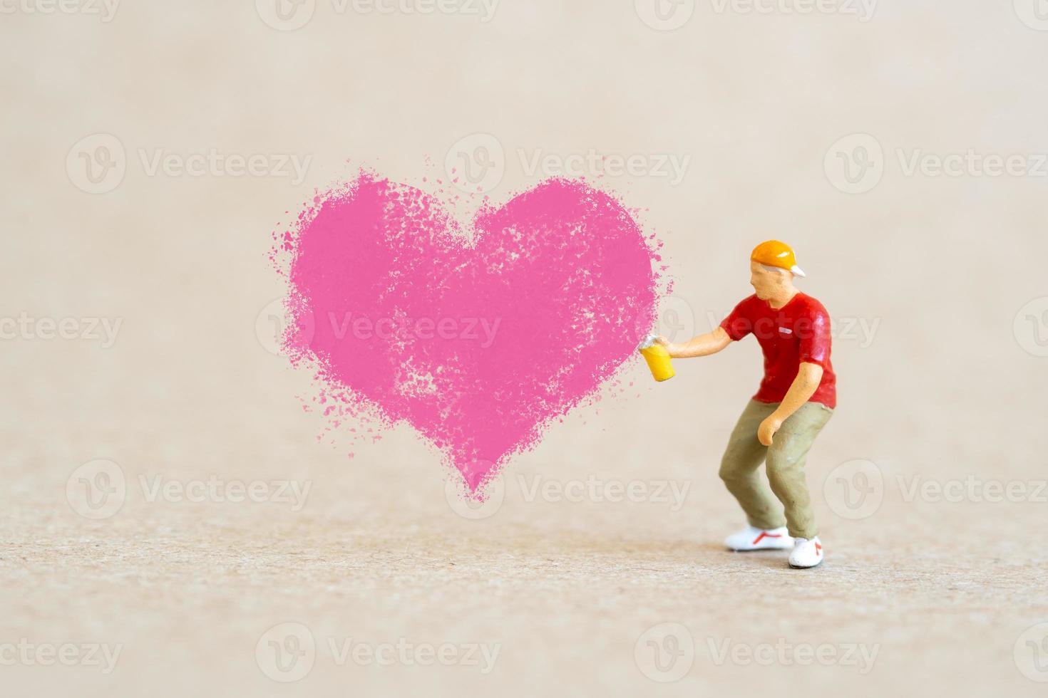 Artist holding dispenser and spraying with red heart shapes, Valentine day concept photo