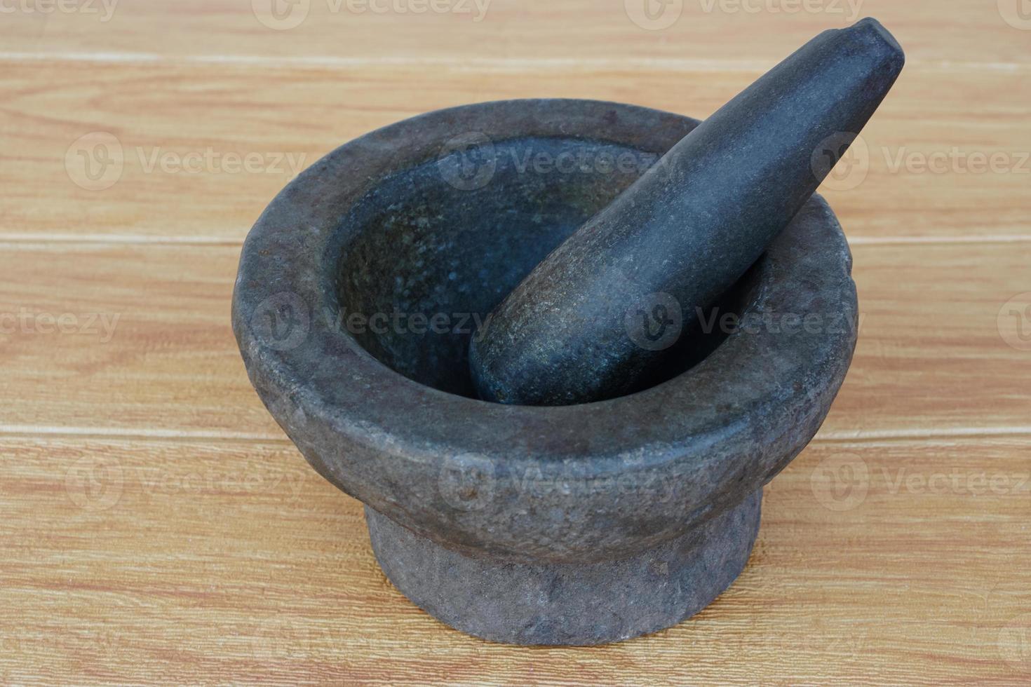 Old granite stone mortar and pestle. Concept, kitchen utensils .Thai cooking tool, use to  pound chili paste or curry paste. photo