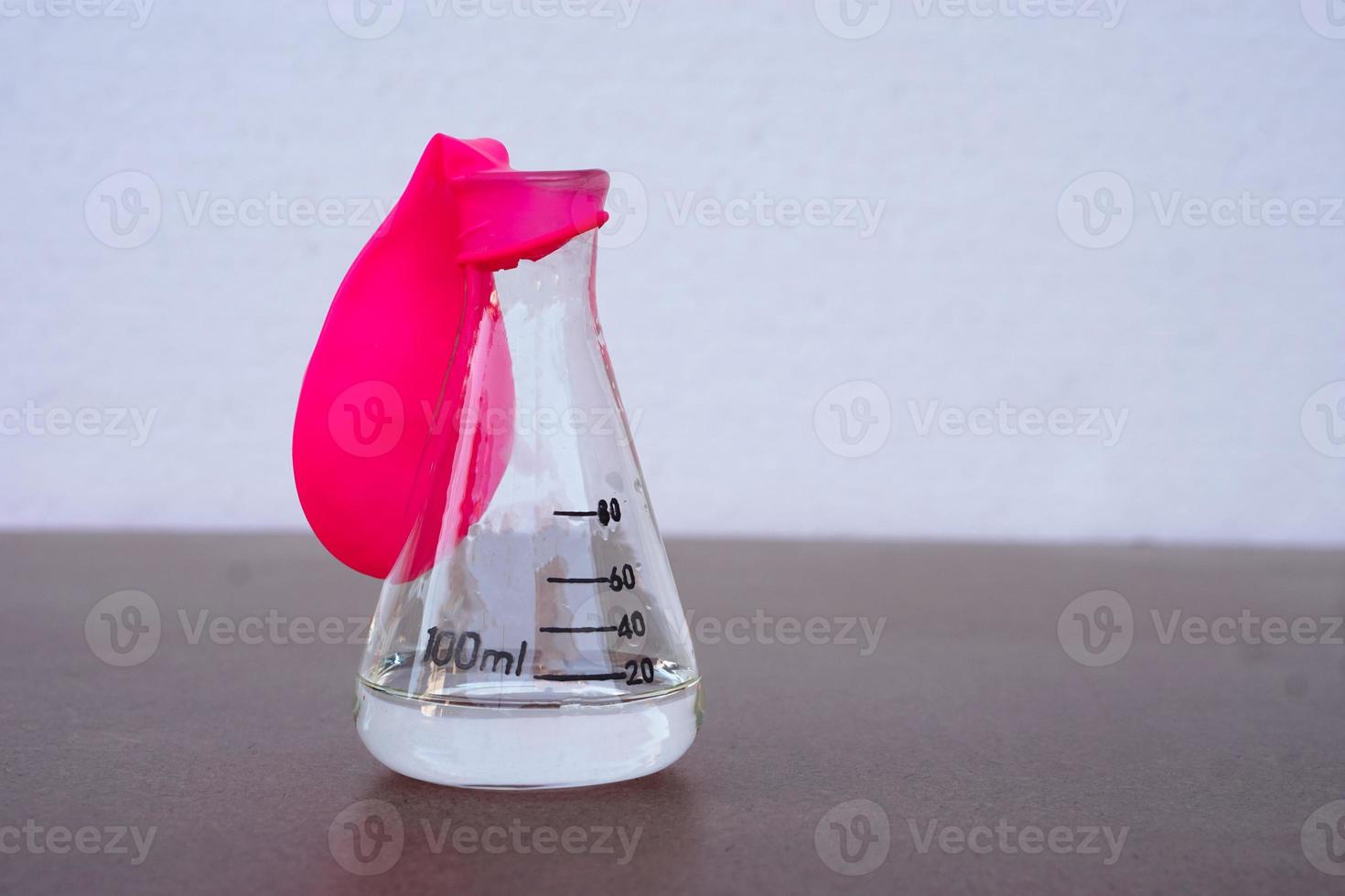 Science experiment, flat pink balloon with no air on top of transparent test bottle. First step of the experiment about air or gas reaction.by using baking soda and vinegar.Concept,  Science Education photo
