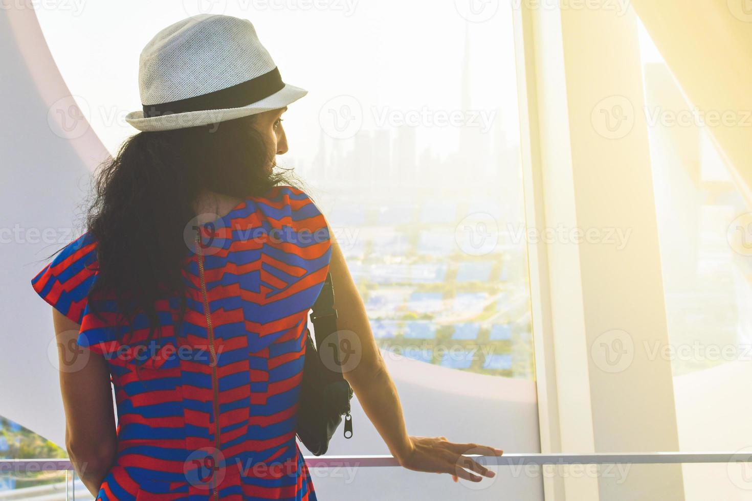 Dubai, UAE, 2022 - caucasian tourist in famous Frame landmark enjoy panorama of city skyline. Visit UAE holiday travel destinations in Dubai concept photo