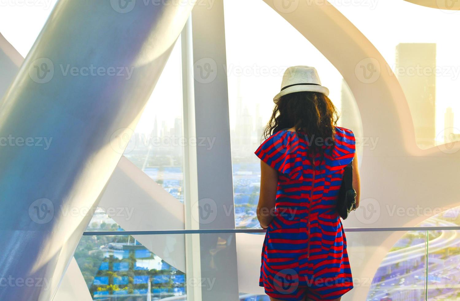 Dubai, UAE, 2022- caucasian tourist in famous Frame landmark enjoy panorama of city skyline. Visit UAE holiday travel destinations in Dubai concept photo