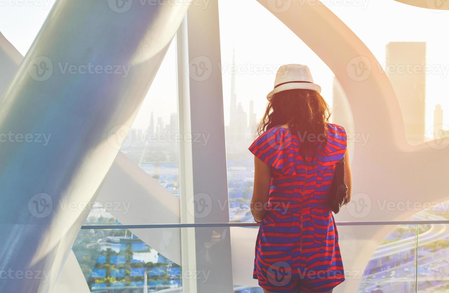 Dubai, UAE, 2022 - caucasian tourist in famous Frame landmark enjoy panorama of city skyline. Visit UAE holiday travel destinations in Dubai concept photo