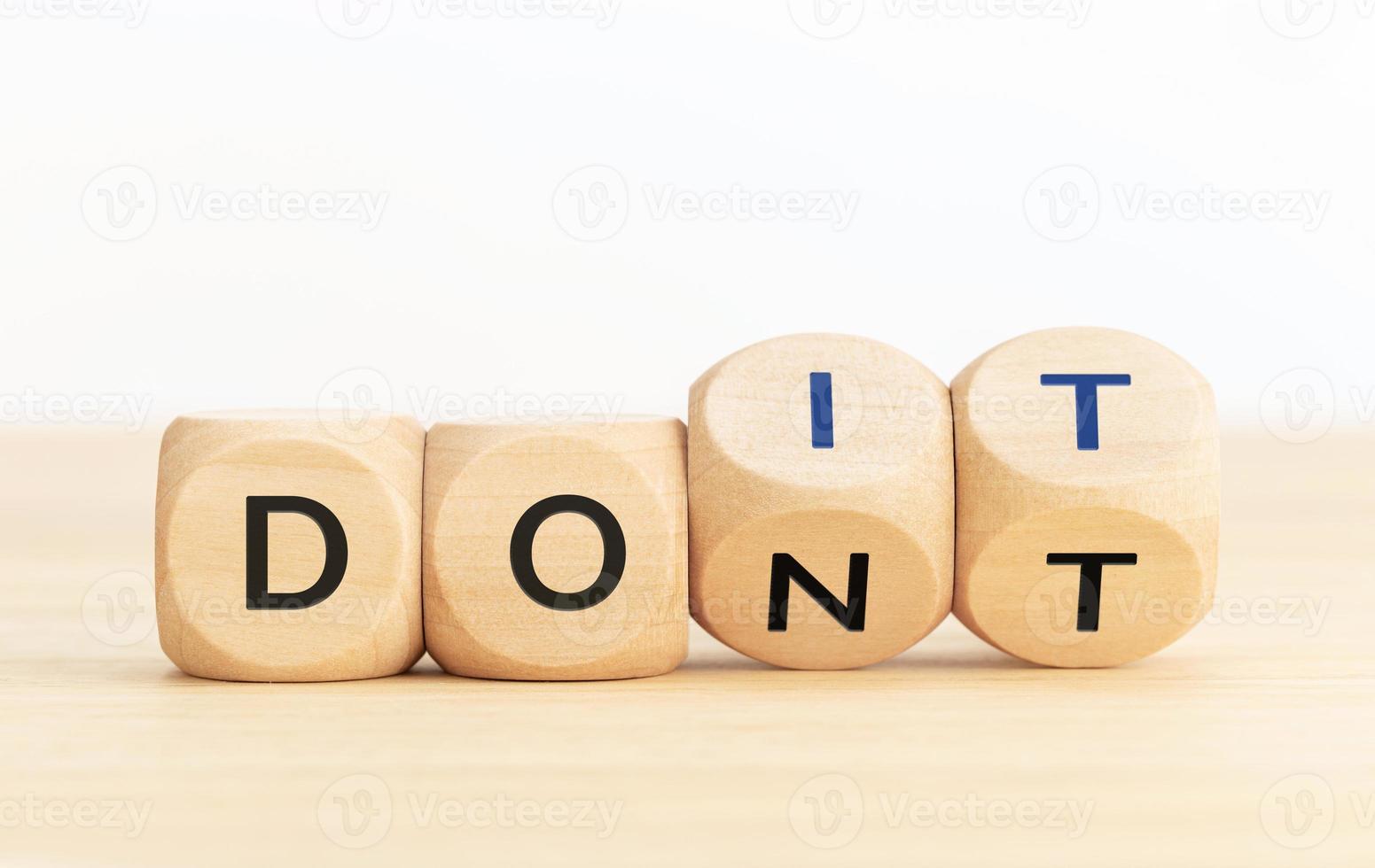 From Dont to Do it concept.Text on wooden blocks and changing dices photo
