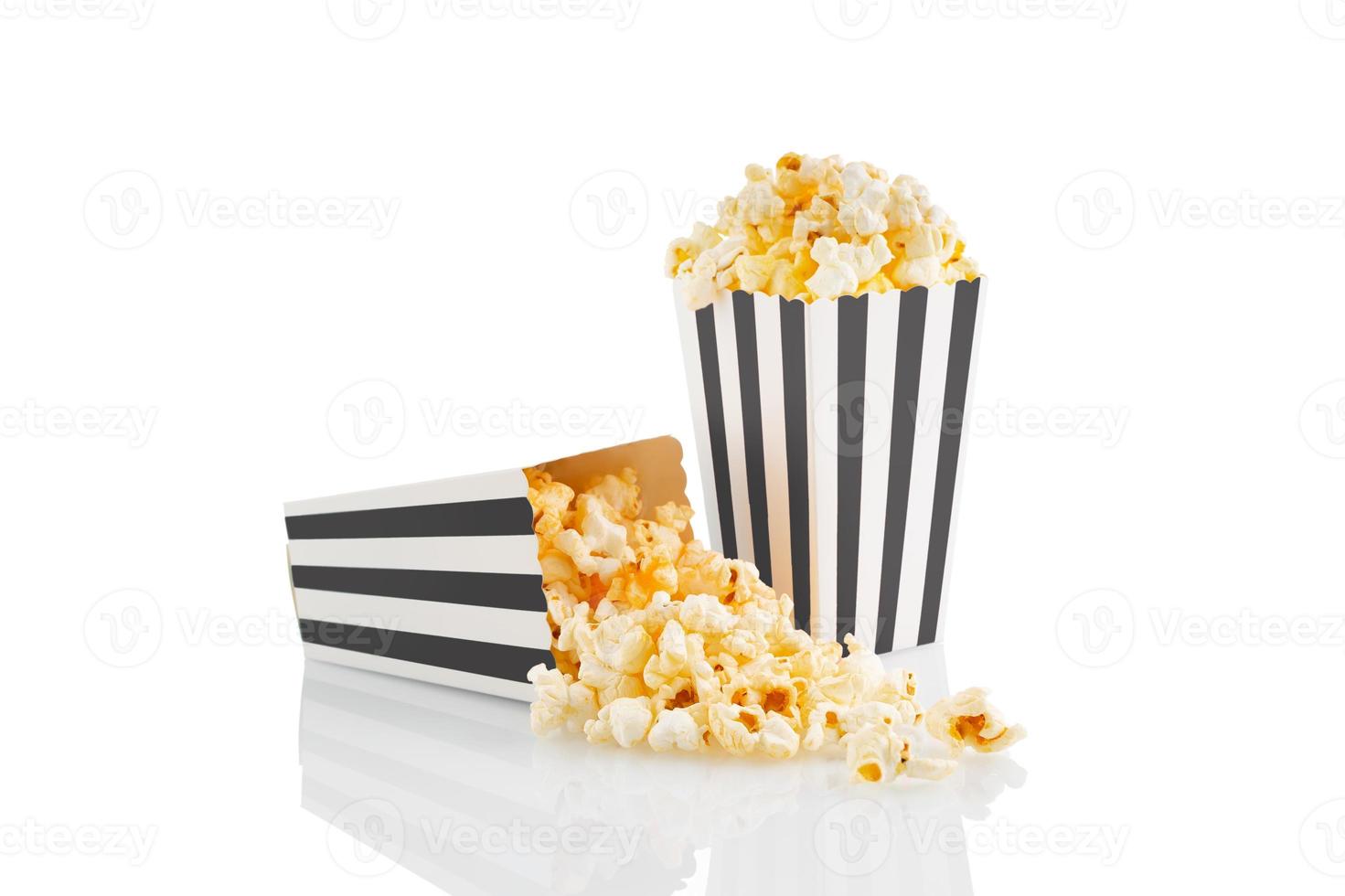 Two blakc white striped carton buckets with tasty cheese popcorn, isolated on white background photo