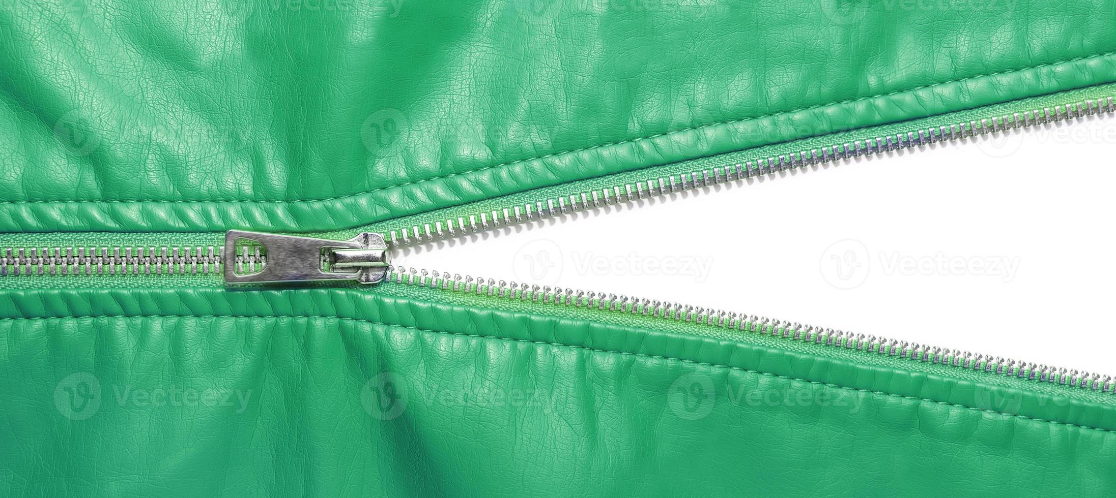 Green leather texture and open metal zipper isolated on white background photo