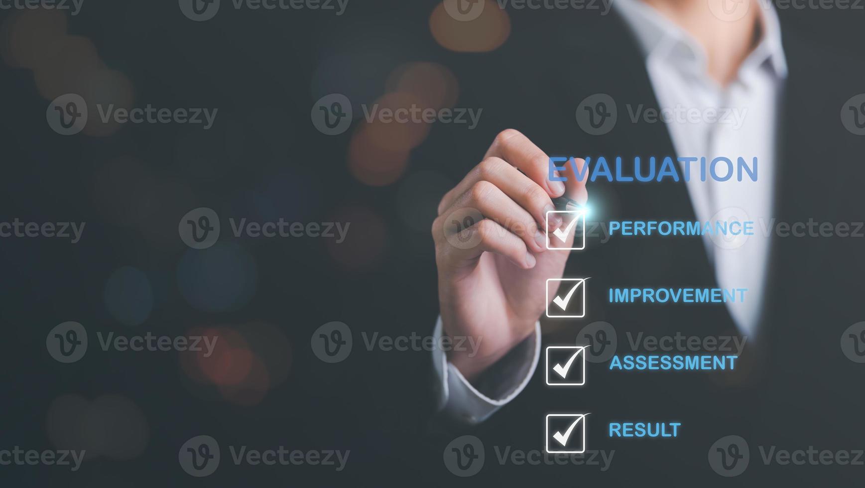 Businessman using a pen to point at an icon,result evaluation concept,plan review through professional analysis,review and rating to evaluate past performance,for the best performance and quality photo