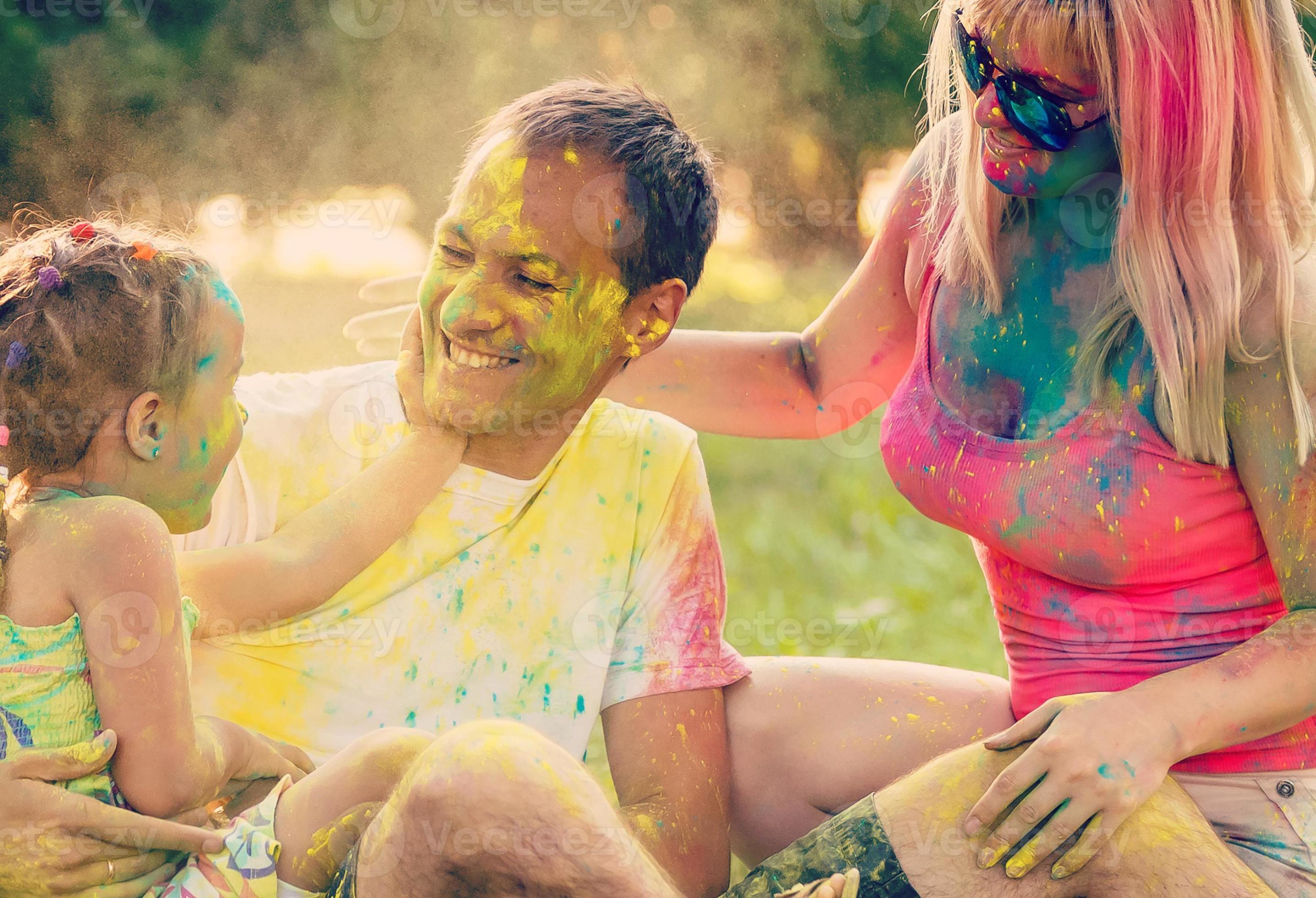 Father mother and daughter playing in the park and showering with paints 17334599 Stock Photo at