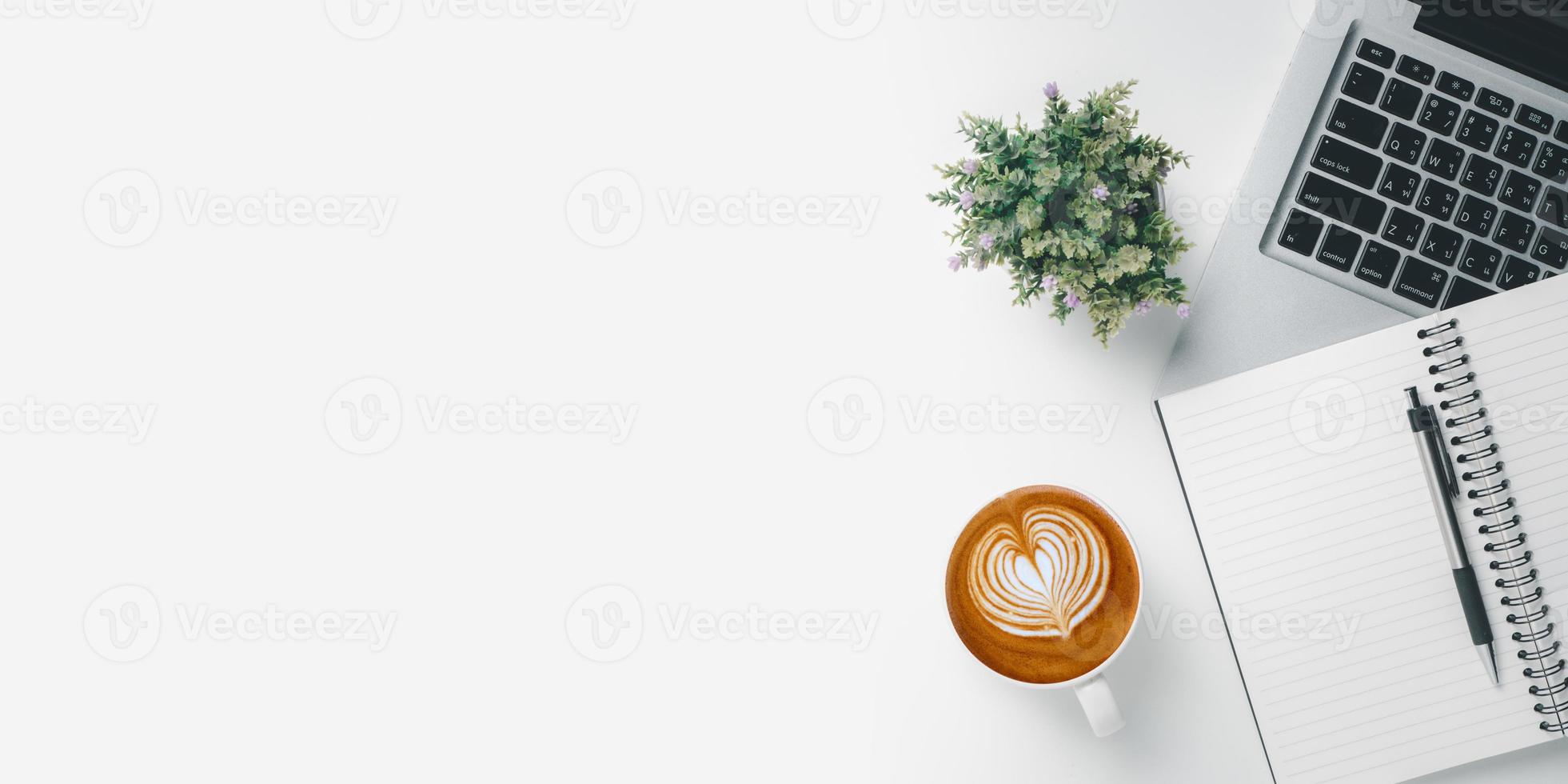 Office desk with computer, Pen, mouse, notebook, Cup of coffee on white background, Top view with copy space, Mock up. photo