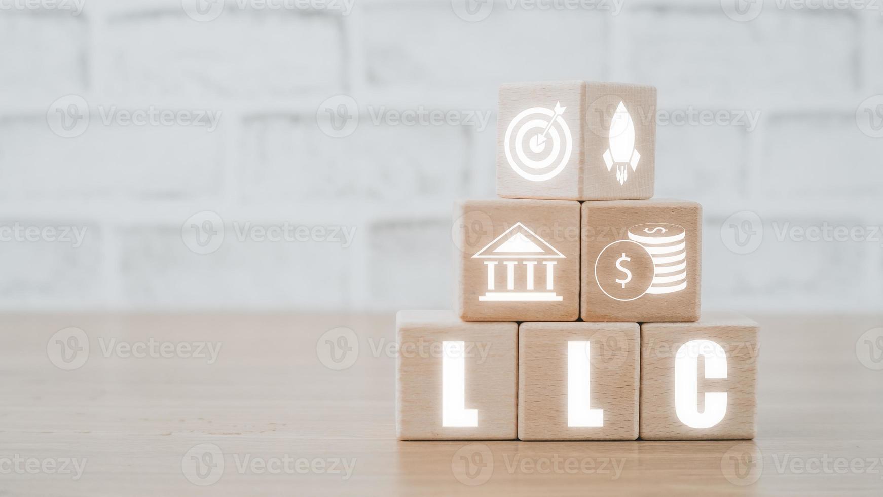 Limited Liability Company Concept, Wooden block on desk  with limited liability company icon on Vr screen. photo