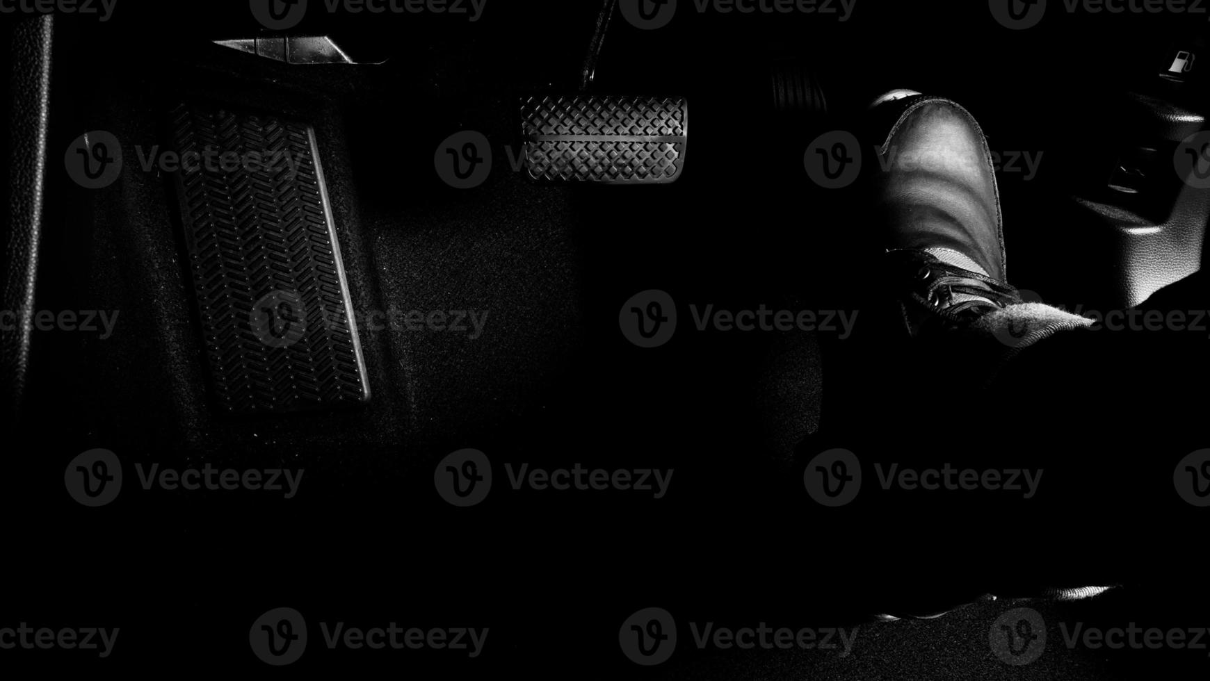 Close up foot press or push foot break and accelerate pedal of a car to drive ahead. photo