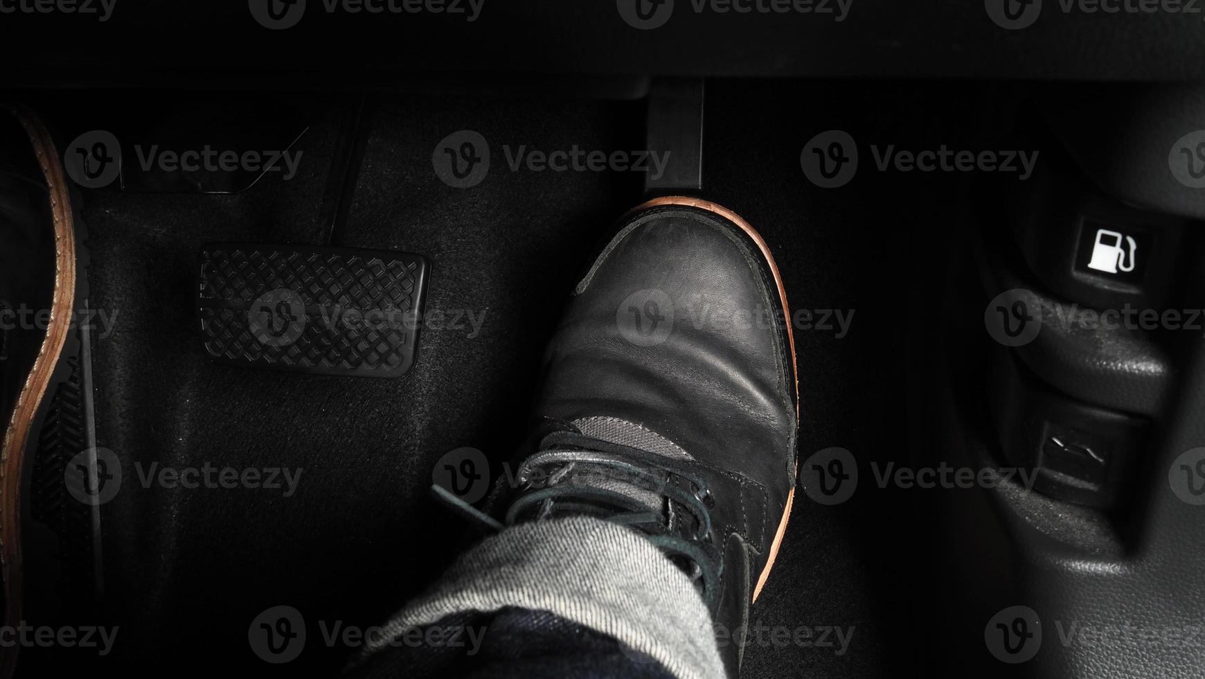 Close up foot press or push foot break and accelerate pedal of a car to drive ahead. photo