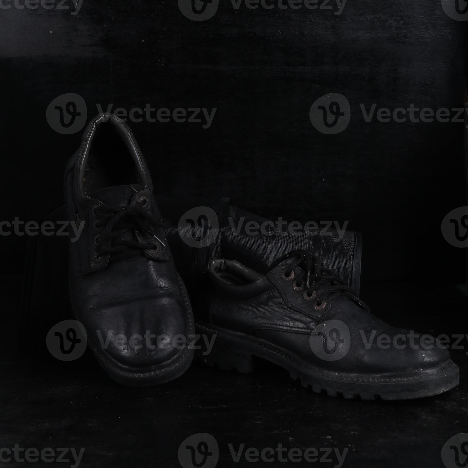 Pair of black male classic shoes on black background. Dusty shoes