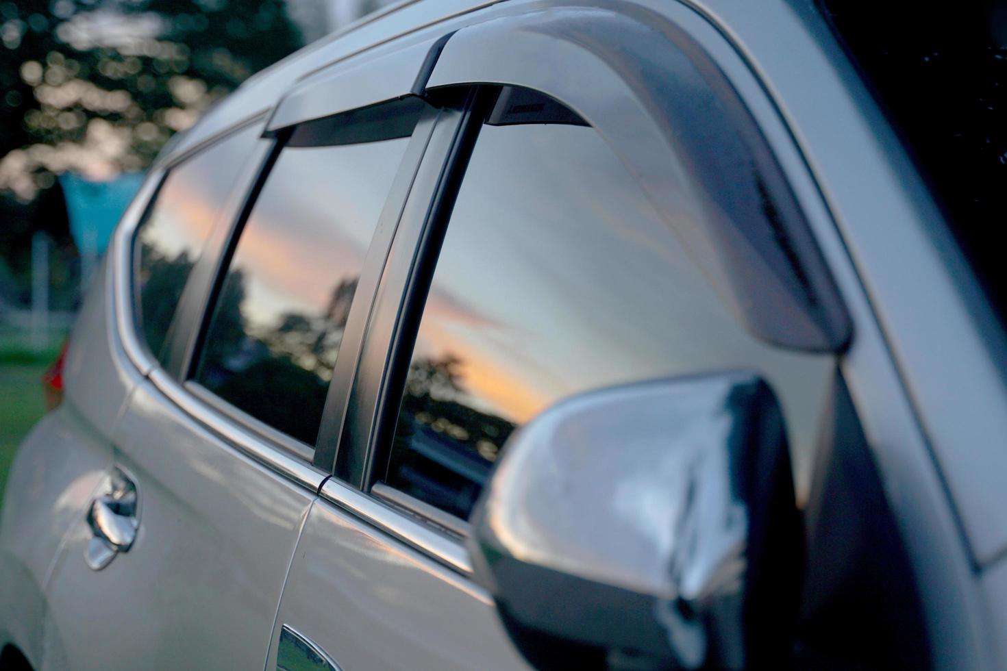 Reflection of light from the setting sun in the window of a car, which is the behavior of light waves. soft and selective focus. photo