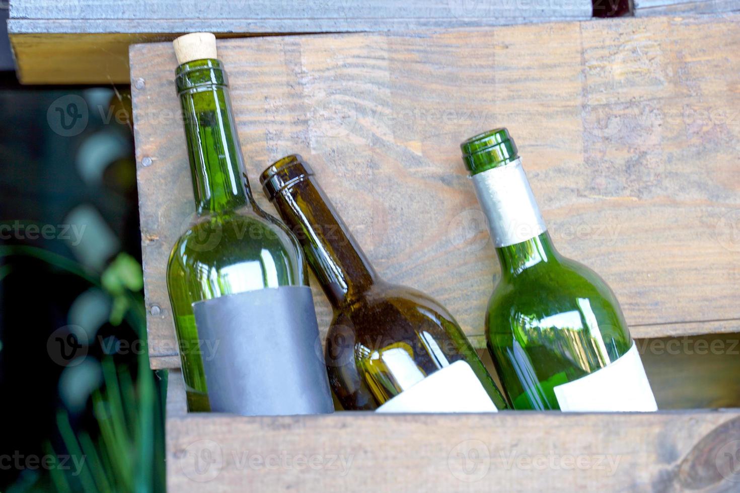 Several brands of old wine bottles in wooden crates used to decorate the atmosphere of the restaurant. Soft and selective focus photo