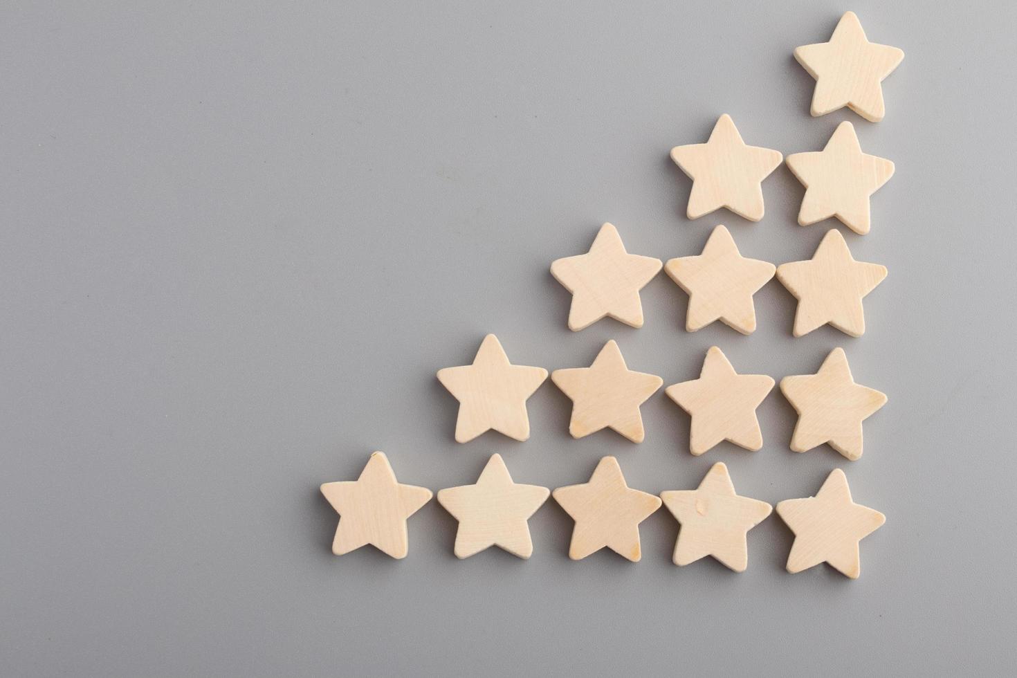 Five wooden stars on gray background.Copy space. photo