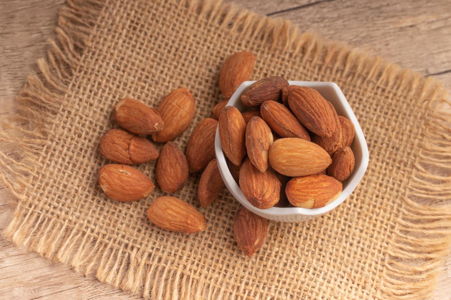 Salted almonds in a white cup.Copy space. photo