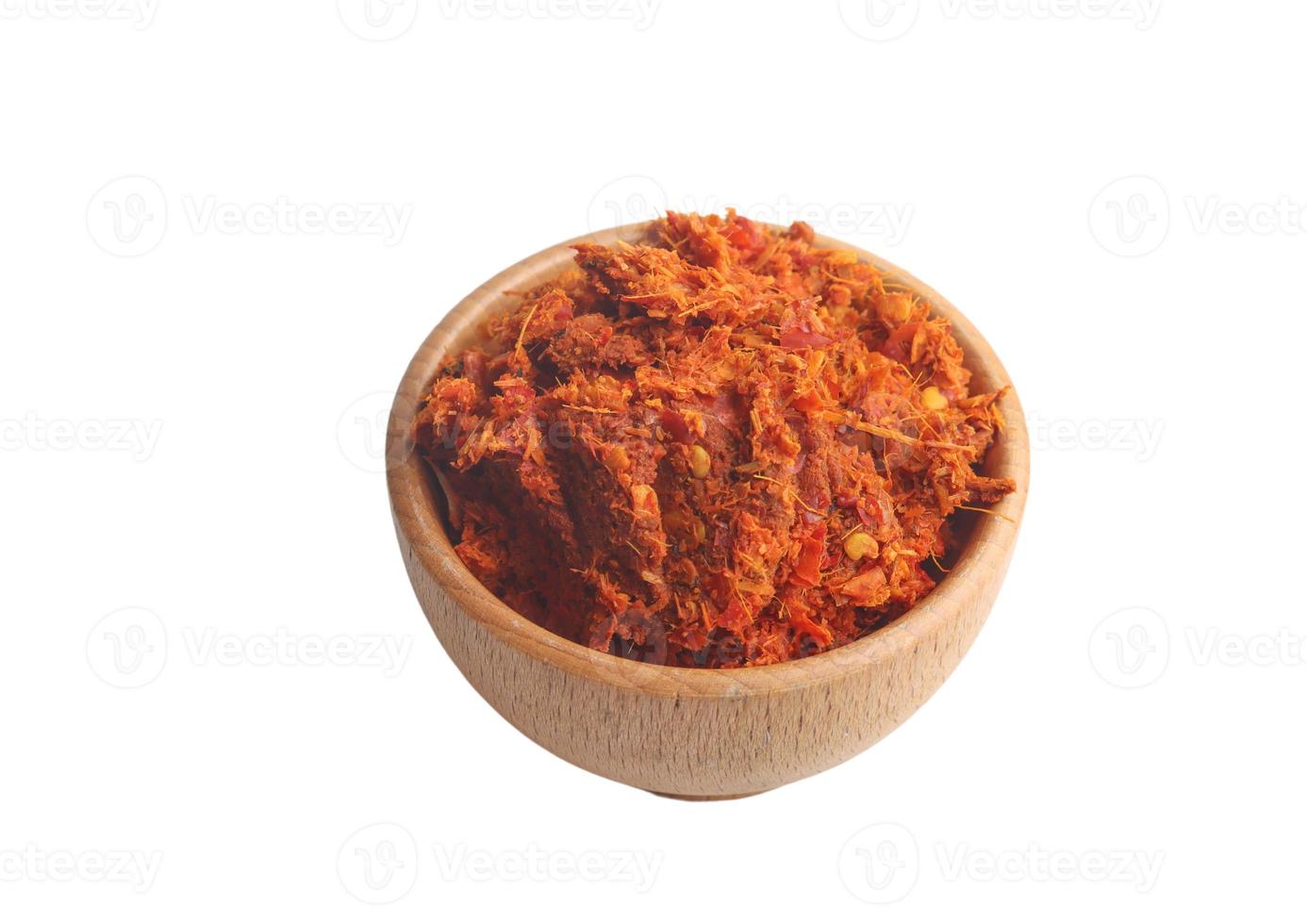 Chili peppers in wooden cup on white background photo