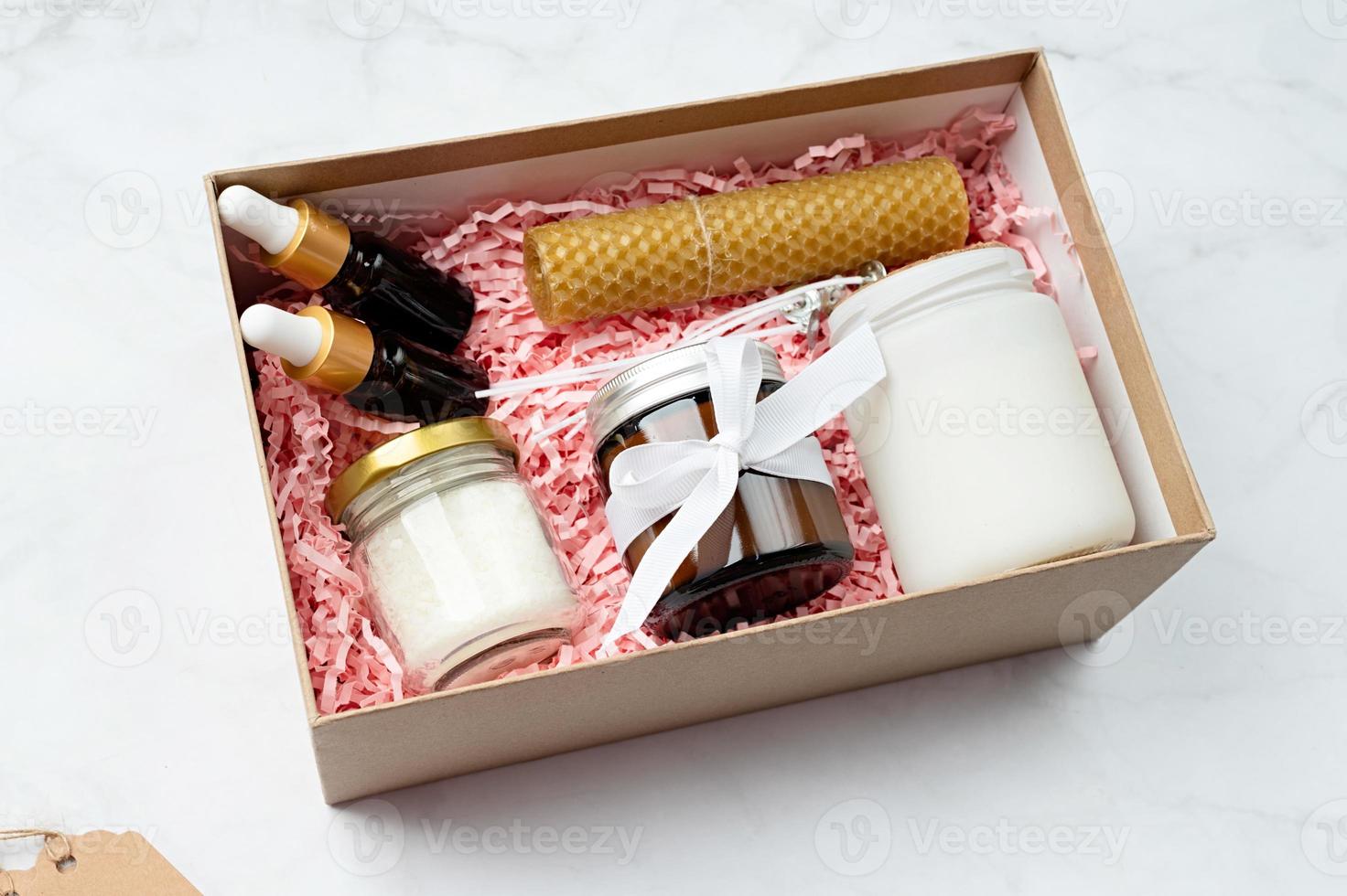 Gift box with candle making tools, candle, soy wax, wicks and aroma oil bottles photo