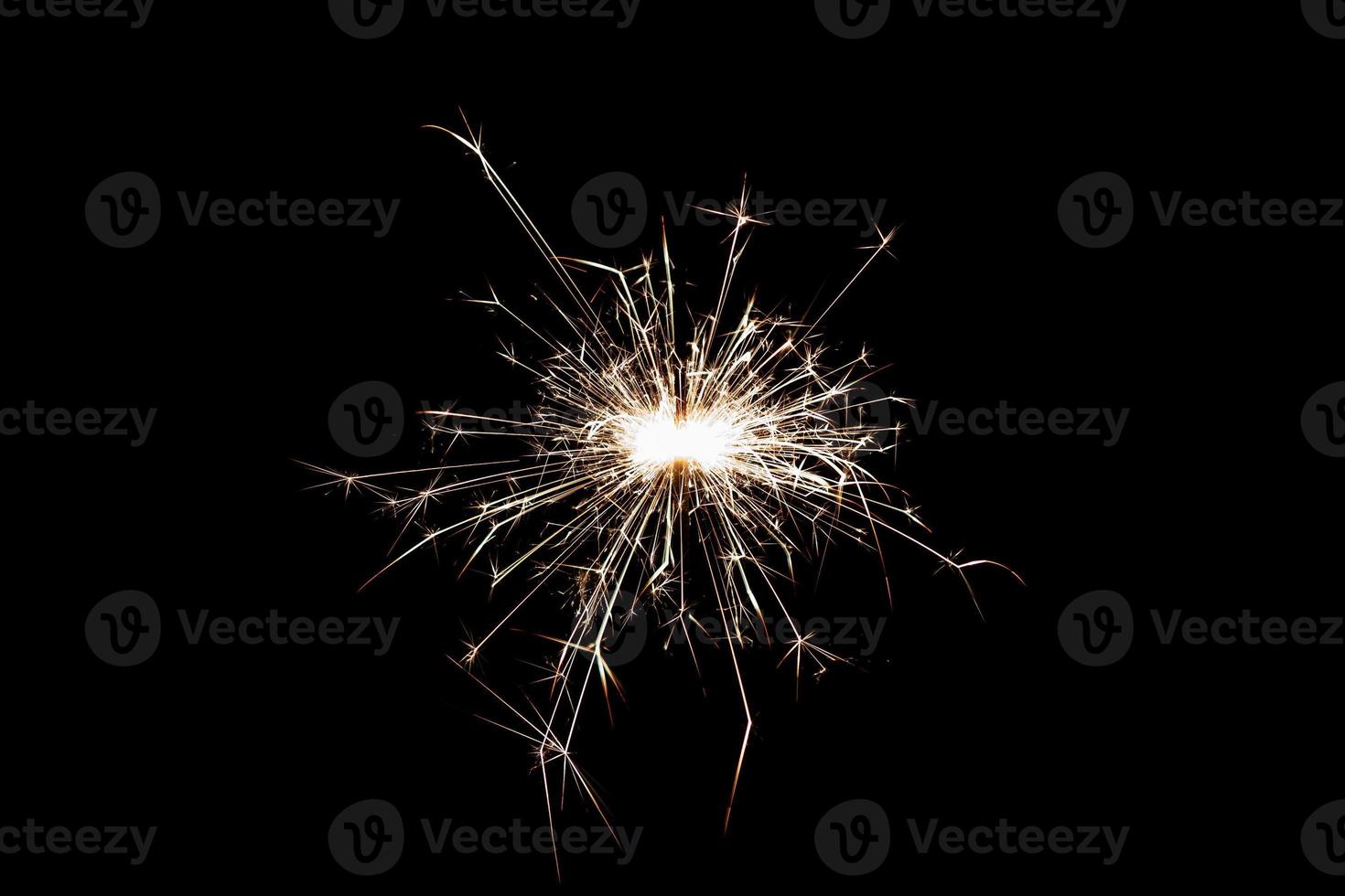 Burning sparkler isolated on black background. Fireworks theme. Light effect and texture. photo