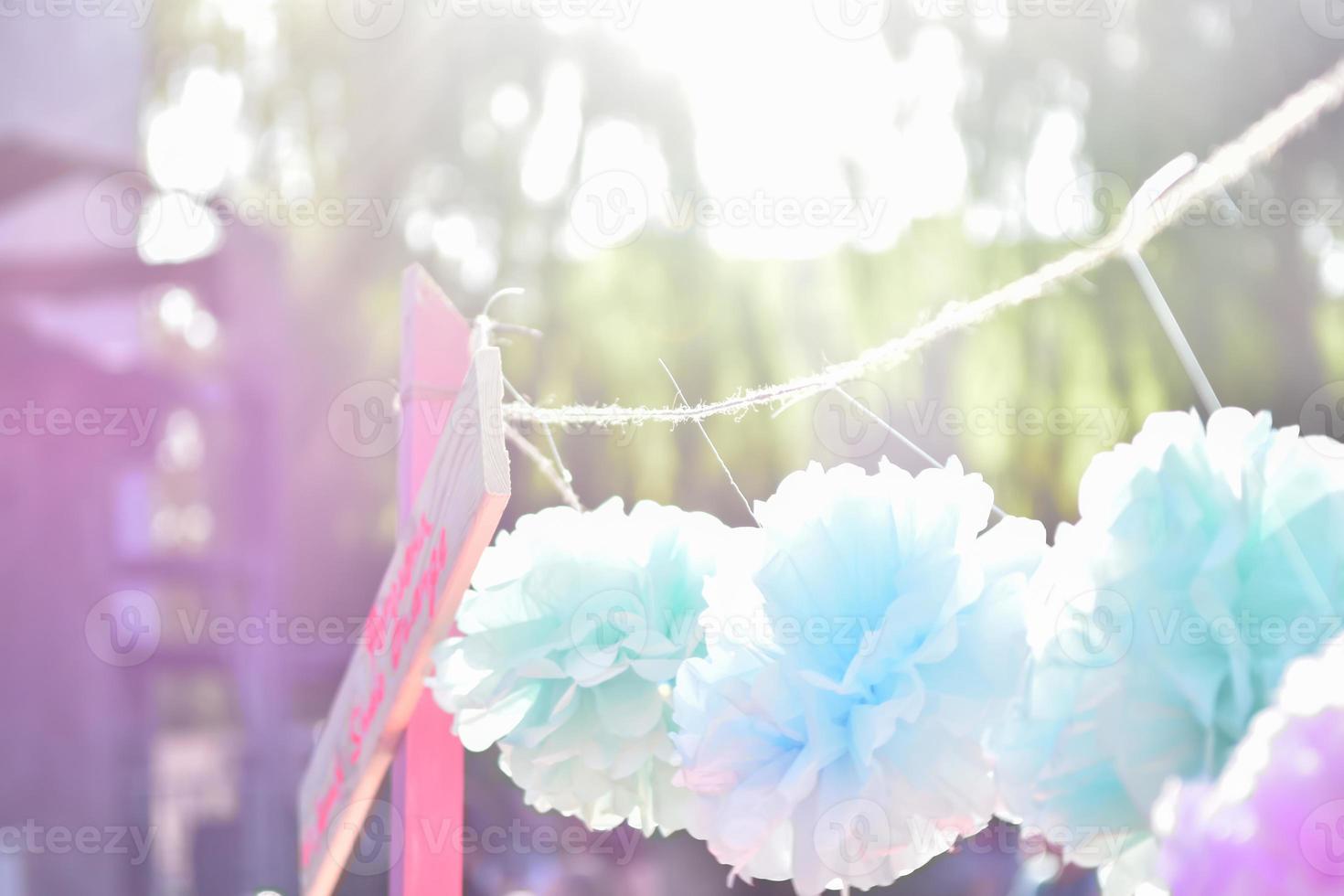 delicate colored summer background shot at sunset with handmade paper flowers photo