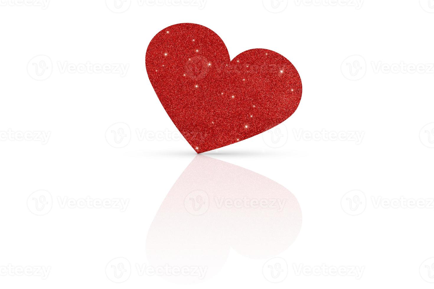 One glittering red heart on a white glossy background. Valentine's Day photo