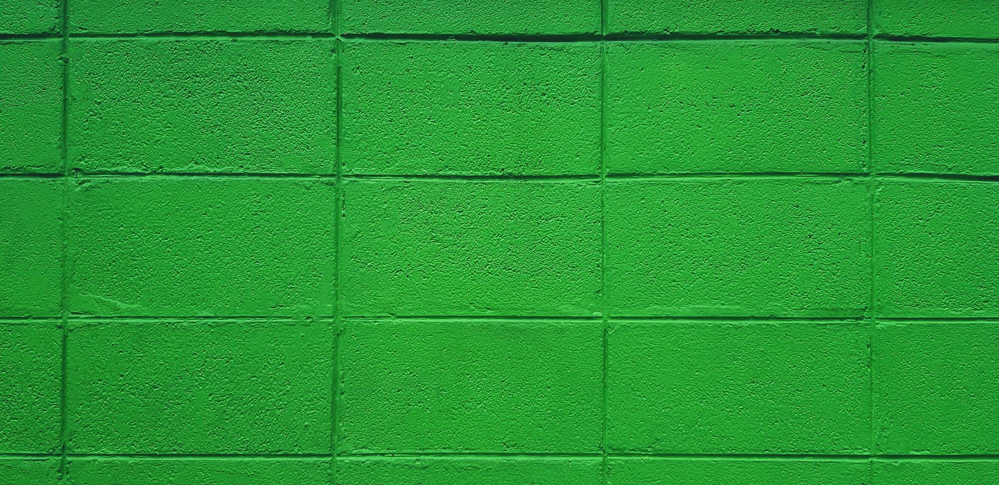 Green brick or block wall for background. Pastel and colorful painted of brickwork wallpaper. photo