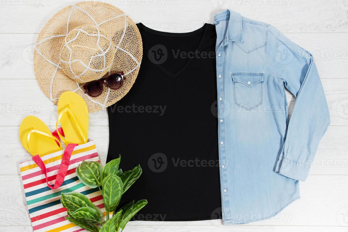 T shirt black and slippers. T-shirt Mockup flat lay with summer accessories. Hat, yellow flip flops and sunglasses on wooden floor background. Copy space. Template blank canvas. Front top view. photo